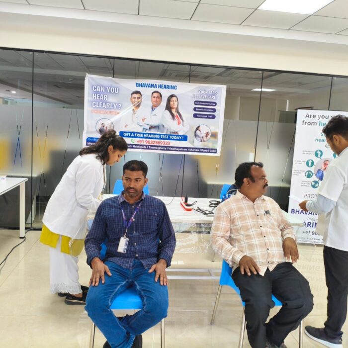 “Patient receiving a free hearing assessment from an expert audiologist during a hearing camp.”